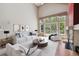 Bright living room with tall ceilings, neutral furniture, and scenic views from the large windows at 14186 E Hampden Pl, Aurora, CO 80014