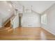 Expansive living room featuring gleaming hardwood floors and an open staircase at 14186 E Hampden Pl, Aurora, CO 80014