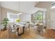 Open-concept living and dining area filled with natural light and stylish decor at 14186 E Hampden Pl, Aurora, CO 80014