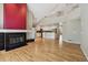 Open-concept living room featuring a fireplace and views into the kitchen and second-story loft area at 14186 E Hampden Pl, Aurora, CO 80014