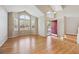 Inviting living room featuring hardwood floors, vaulted ceiling, and large windows at 14186 E Hampden Pl, Aurora, CO 80014