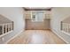 Bright loft space with hardwood floors, built-in shelving, and a view of the neighborhood at 14186 E Hampden Pl, Aurora, CO 80014