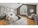 Serene bedroom features vaulted ceiling, large window, and cozy sitting area at 14186 E Hampden Pl, Aurora, CO 80014