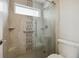 Shower with glass door, tile surround, rainfall shower head and window at 14186 E Hampden Pl, Aurora, CO 80014