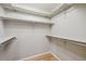 Walk-in closet with built in shelving and hardwood floors at 14186 E Hampden Pl, Aurora, CO 80014