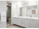 Modern bathroom features double sink vanity, large mirror, and glass enclosed shower at 2880 Zuni St # 408, Denver, CO 80211