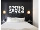 Bedroom with black accent wall, modern art, side tables and stylish sconces at 2880 Zuni St # 408, Denver, CO 80211