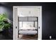 Unique bedroom featuring bunk beds set against a dark accent wall and modern decor at 2880 Zuni St # 408, Denver, CO 80211