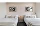 Cozy bedroom features two twin beds with white bedding and minimalist decor at 2880 Zuni St # 408, Denver, CO 80211