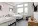 Bright bedroom with two beds, large window, stylish decor, and neutral color scheme at 2880 Zuni St # 408, Denver, CO 80211