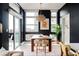 Modern dining room featuring dark walls, a statement light fixture, and large bright windows at 2880 Zuni St # 408, Denver, CO 80211