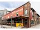 The Post Chicken & Beer restaurant with a bright red brick facade and an inviting outdoor patio at 2880 Zuni St # 408, Denver, CO 80211