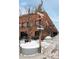 Commercial building with multiple signs, tree, and brick facade, creating a vibrant and engaging street view at 2880 Zuni St # 408, Denver, CO 80211