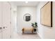 Inviting hallway with a decorative mirror, bench, and wall art, enhancing the home's modern aesthetic at 2880 Zuni St # 408, Denver, CO 80211