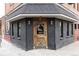 Charming corner entrance with a wooden door and dark brick facade at 2880 Zuni St # 408, Denver, CO 80211