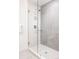 Modern shower with glass door, chrome fixtures, and stylish gray tiling at 2880 Zuni St # 408, Denver, CO 80211