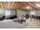 Large unfinished basement featuring concrete walls and exposed ceiling at 4543 S Auckland Ct, Aurora, CO 80015