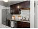 Dark wood cabinets, granite counters, and updated appliances in this kitchen at 100 S Clarkson St # 105, Denver, CO 80209