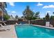 Relaxing pool area with lounge chairs, clear blue water, and lush landscaping in a private area at 100 S Clarkson St # 105, Denver, CO 80209