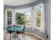 Bright breakfast nook with wraparound windows, charming chairs, and scenic views at 3647 S Uravan St, Aurora, CO 80013