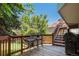 Enjoy outdoor bar-style seating on the wooden deck with views of the backyard and blue sky at 3647 S Uravan St, Aurora, CO 80013