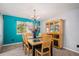 Dining room with a modern chandelier, natural light, and seating for six people at 3647 S Uravan St, Aurora, CO 80013