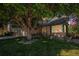 Exterior view of home showcasing a lush front yard, stone accents, and a mature tree providing shade at 3647 S Uravan St, Aurora, CO 80013