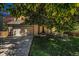 Charming home with a two-car garage, a lush green lawn, and a mature tree offering shade at 3647 S Uravan St, Aurora, CO 80013