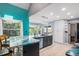 Bright kitchen features a breakfast bar, stainless steel appliances, and plenty of natural light at 3647 S Uravan St, Aurora, CO 80013