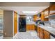 Charming kitchen features modern appliances, ample cabinetry, granite countertops, and tile backsplash at 3647 S Uravan St, Aurora, CO 80013
