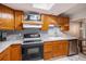 Updated kitchen features modern appliances, ample cabinetry, granite countertops, and tile backsplash at 3647 S Uravan St, Aurora, CO 80013