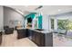 Kitchen featuring a unique island countertop, modern appliances, and a view of the living and dining areas at 3647 S Uravan St, Aurora, CO 80013