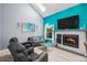 Cozy living room with a fireplace, large windows, and comfortable seating, perfect for relaxing at 3647 S Uravan St, Aurora, CO 80013