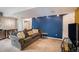 Living room with carpet floors, modern lighting, sofa, and direct access to the room at 3647 S Uravan St, Aurora, CO 80013