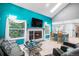 Inviting living room showcases a fireplace, large windows, and open access to the eat-in kitchen at 3647 S Uravan St, Aurora, CO 80013