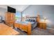Comfortable primary bedroom features natural wood furniture, neutral walls, and great natural light at 3647 S Uravan St, Aurora, CO 80013