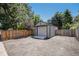 Detached storage shed with a roll-up door and fenced in parking area at 3647 S Uravan St, Aurora, CO 80013