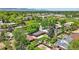 An aerial view showcasing the neighborhood, lush greenery, and mountain views at 6088 Quail Ct, Arvada, CO 80004