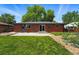 Spacious backyard featuring a lush lawn, garden beds, and a patio for outdoor enjoyment at 6088 Quail Ct, Arvada, CO 80004