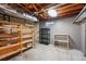 Unfinished basement featuring open rafters, basic shelving and a small basement window at 6088 Quail Ct, Arvada, CO 80004
