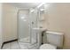 Functional bathroom featuring a standing shower, pedestal sink, and a standard toilet at 6088 Quail Ct, Arvada, CO 80004