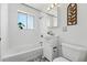 Clean bathroom featuring tile flooring, white vanity, updated fixtures, and shower-tub combination at 6088 Quail Ct, Arvada, CO 80004