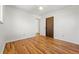 Empty bedroom featuring hardwood floors, fresh white walls, and door to closet at 6088 Quail Ct, Arvada, CO 80004