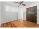 Bright bedroom featuring hardwood floors, a ceiling fan, and closet storage at 6088 Quail Ct, Arvada, CO 80004