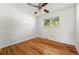 Empty bedroom featuring hardwood floors, fresh white walls, and sunny windows offering peaceful views at 6088 Quail Ct, Arvada, CO 80004
