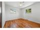 Empty bedroom featuring hardwood floors, fresh white walls, and sunny windows offering peaceful views at 6088 Quail Ct, Arvada, CO 80004