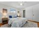 Cozy bedroom featuring a large bed, hardwood floors, ample closet space, and natural light at 6088 Quail Ct, Arvada, CO 80004