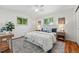 Bright bedroom featuring hardwood floors, fresh white walls, and sunny windows offering peaceful views at 6088 Quail Ct, Arvada, CO 80004