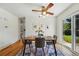 Dining room with modern table, stylish ceiling fan, hardwood floors, and sliding glass door to backyard at 6088 Quail Ct, Arvada, CO 80004