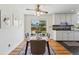 Dining room with modern table, stylish ceiling fan, hardwood floors, and access to the kitchen at 6088 Quail Ct, Arvada, CO 80004
